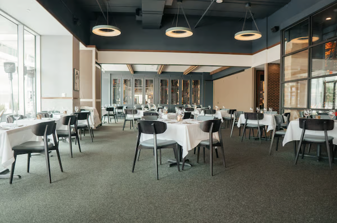The dining room of Masraff's restaurant features grey and beige details and modern accents. 